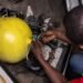 Jide Fashetire, Founder of City Mechanic, sets up a gas bottle in a minibus to convert it to gas combustion in City Mechanic, a Compressed Natural Gas (CNG) centre in Lagos, on November 12, 2024. (Photo by OLYMPIA DE MAISMONT / AFP)